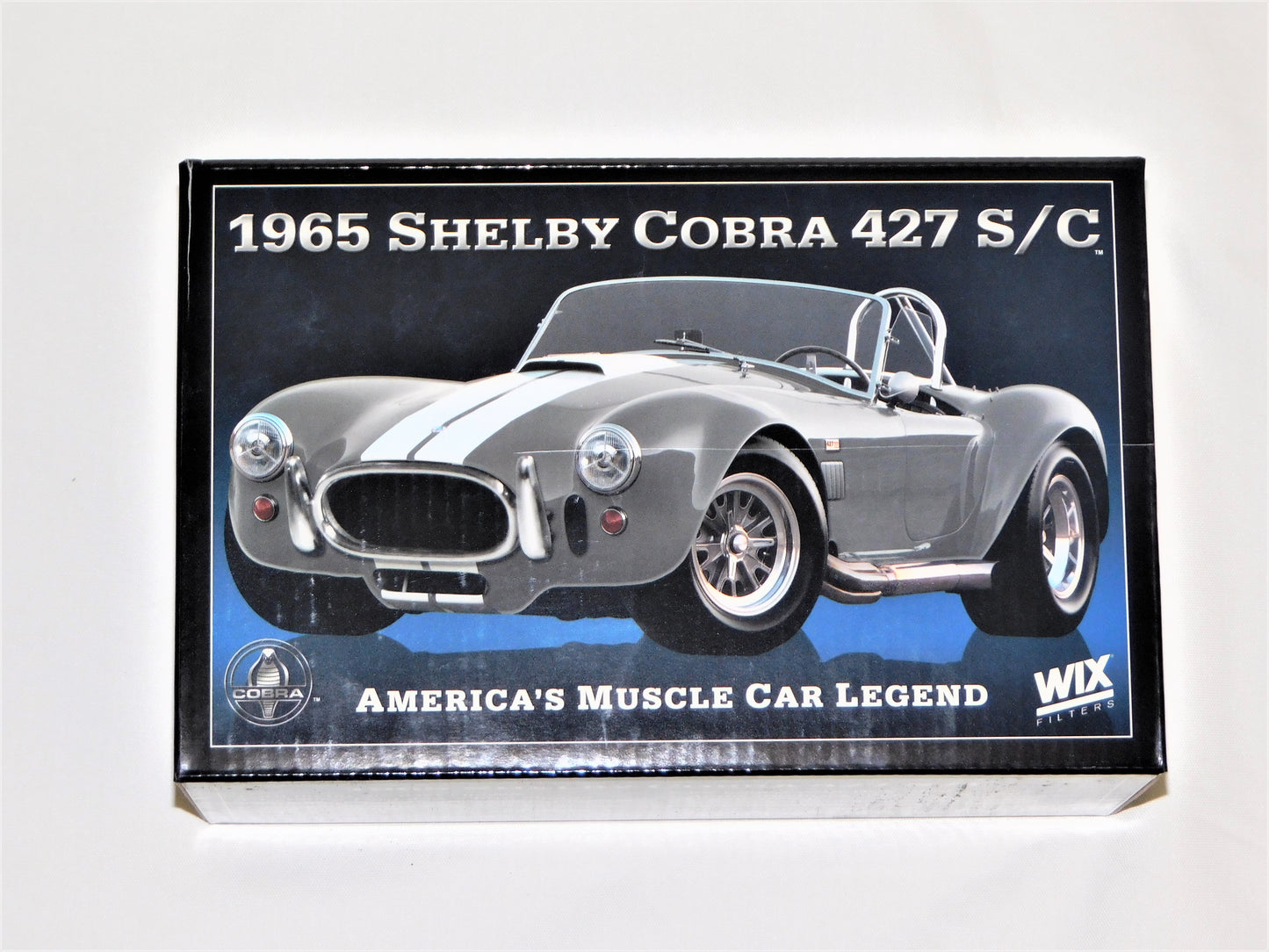 STK 10156  WIX 1965 Dark Grey Metallic Shelby Cobra 1/24 Die Cast *Price Includes Tax and Shipping within the US*
